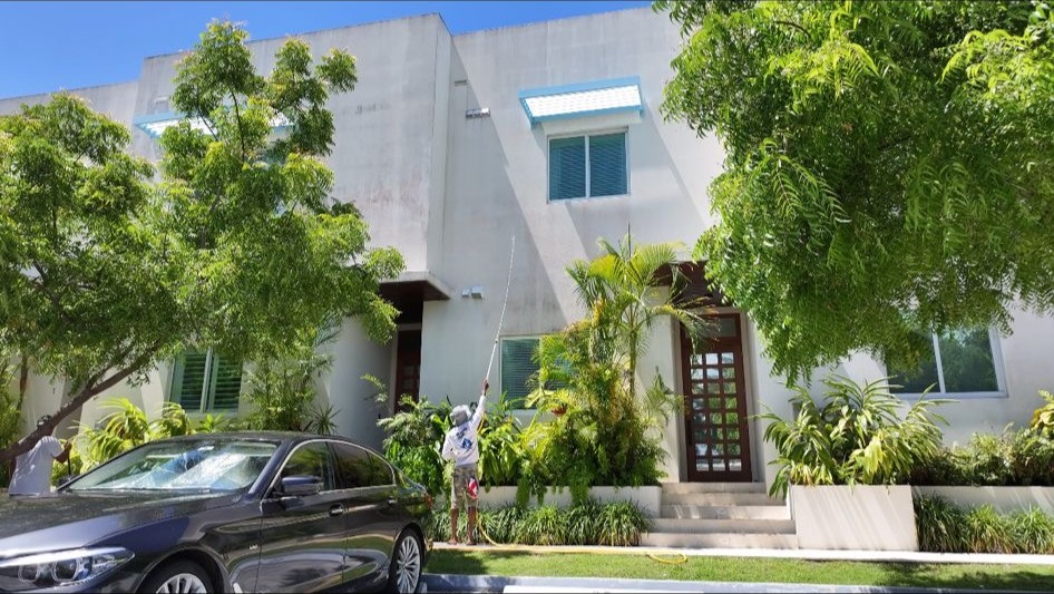 Soft washing a home exterior in Grand Cayman